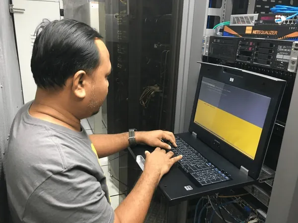 Cybergate IT engineer working in a server room in Malaysia