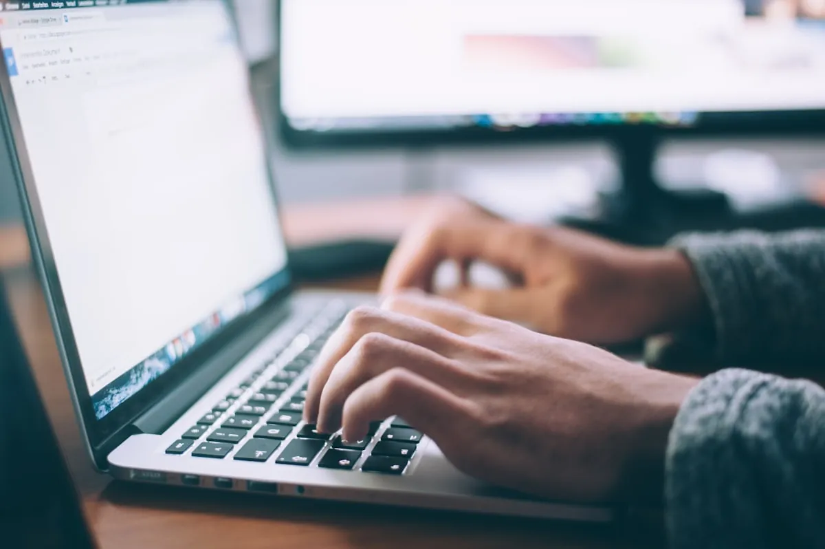 Microsoft 365 and Google Workspace on a laptop for a Malaysian business